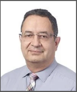 Siamack Nemazie in grey shirt with checked tie and glasses